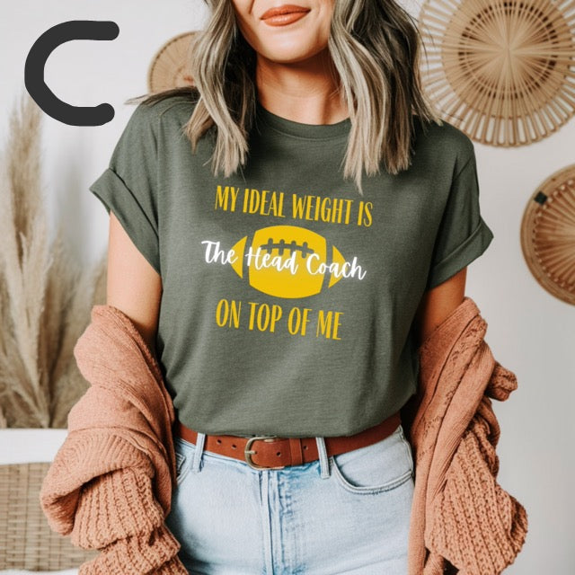 Person wearing a green t-shirt with humorous text design, standing against a neutral background.